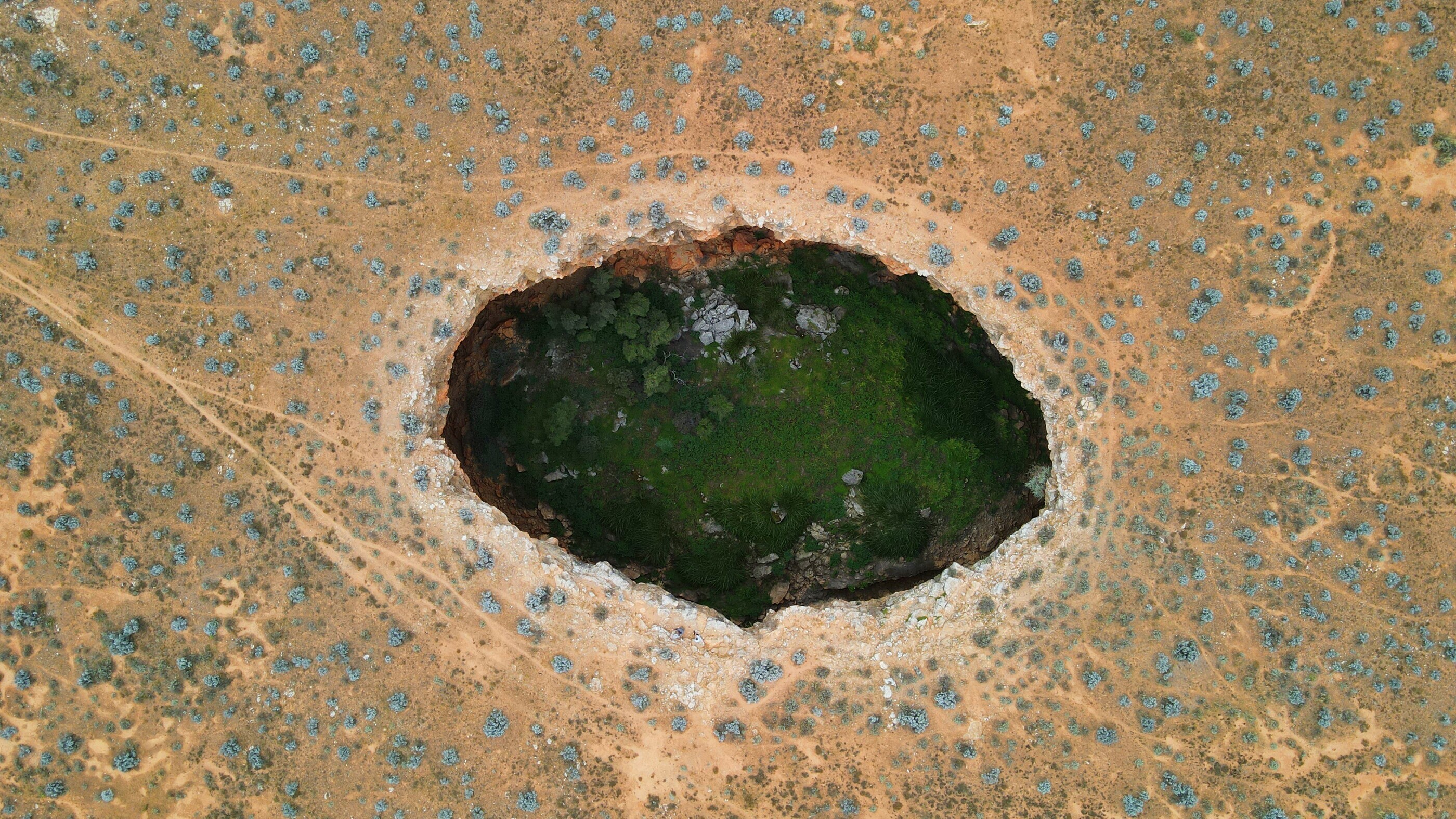 Kestral Cavern 1, on the ground you can barely see the hole until you are 50m from it! (humans for scale)